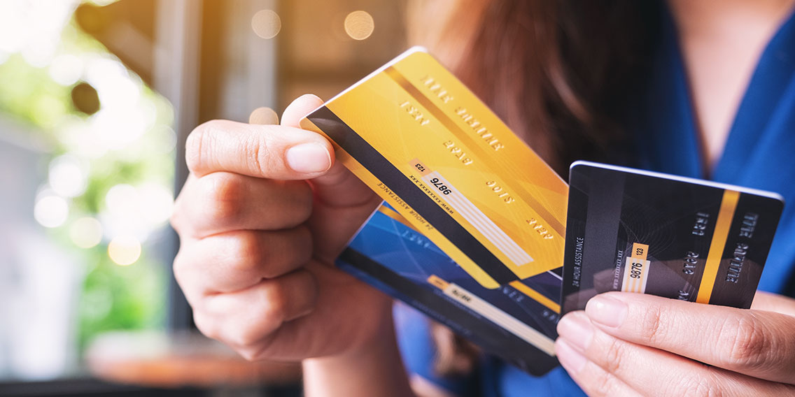 person holding credit cards
