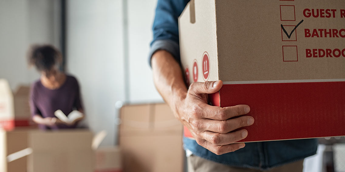 man holding moving boxes