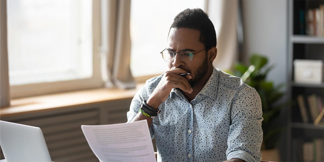 man researching homebuying on laptop