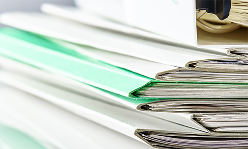 files and binder on a desk