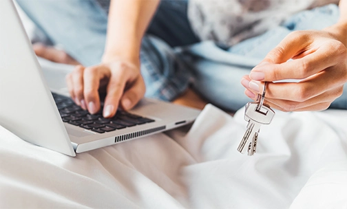 couple looking at a house on a laptop