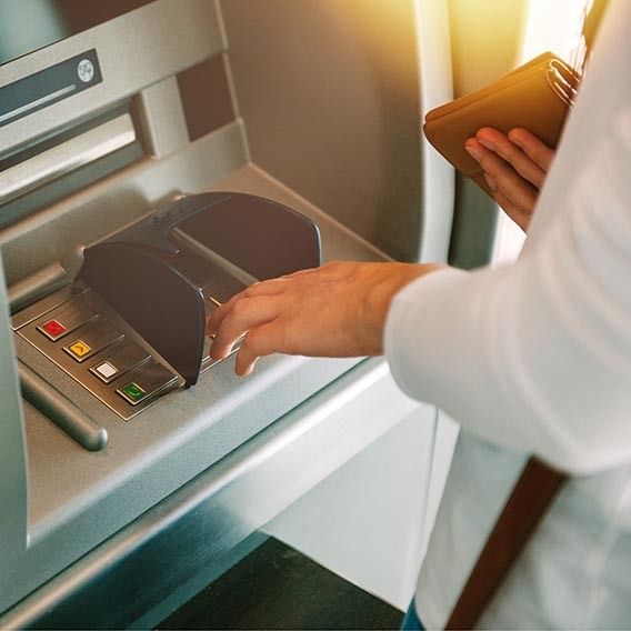 bank customer making a transaction at an ATM