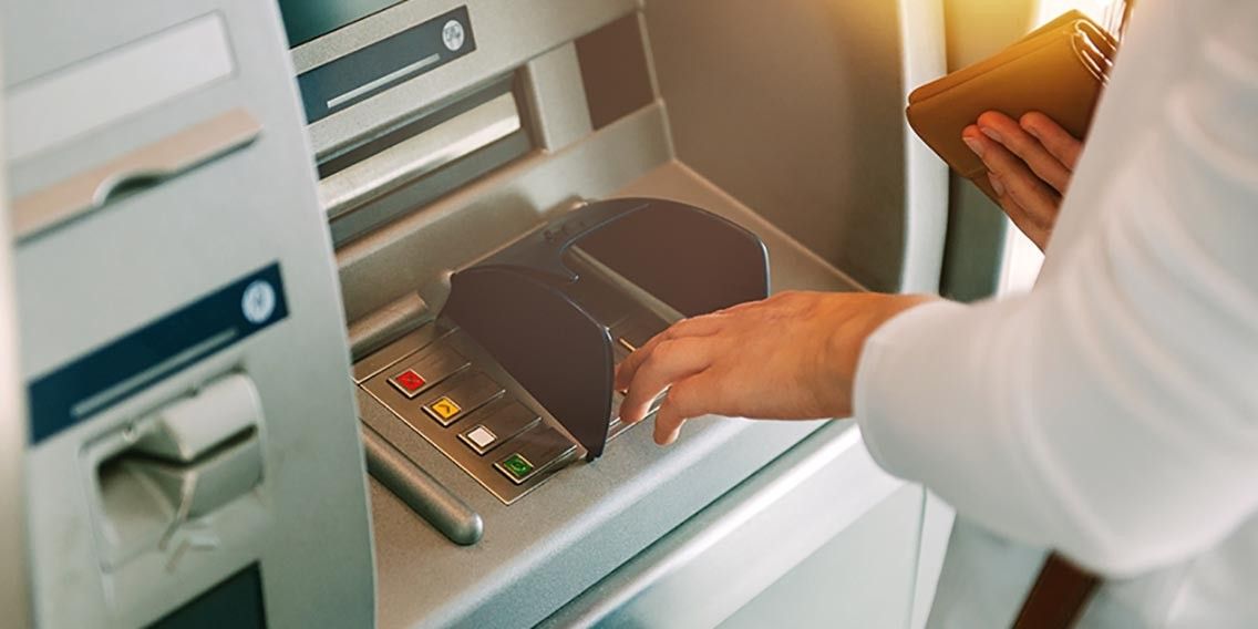 bank customer making a transaction at an ATM