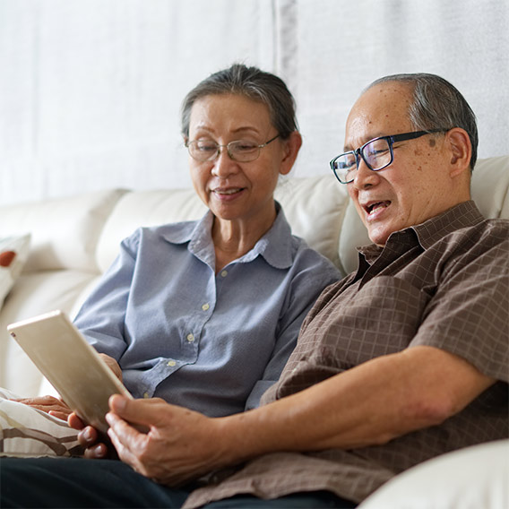 older couple on couch with tablet