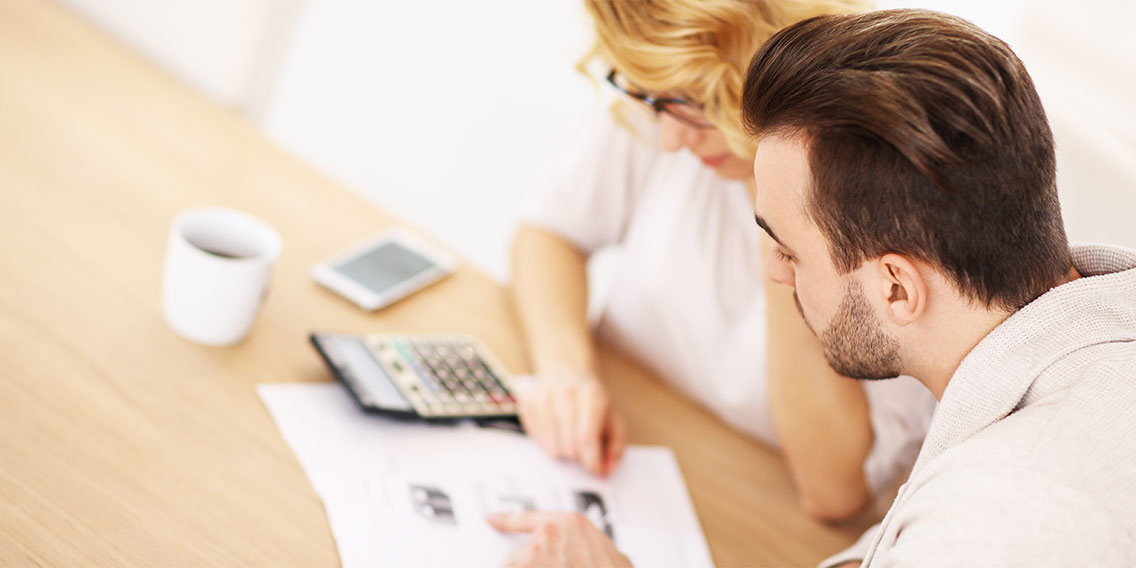 Couple calculating a budget together
