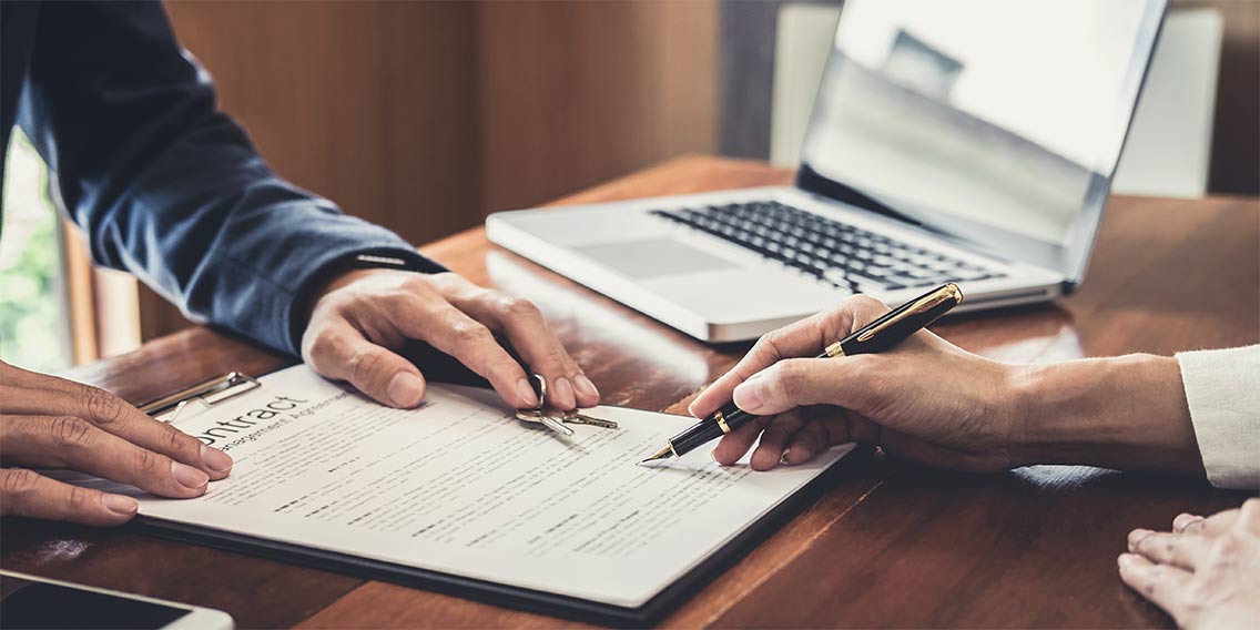 two people going over a mortgage insurance contract