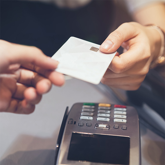 man paying with vcredit card at credir card machine