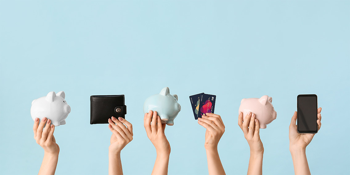 hands holding credit cards, wallets, and piggy banks