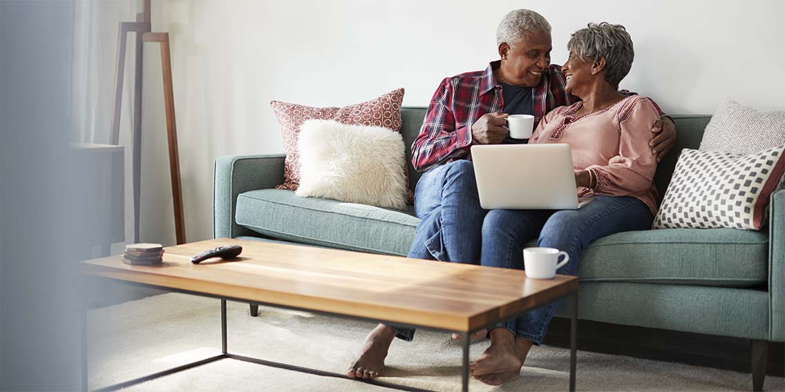 older couple on couch with laptop