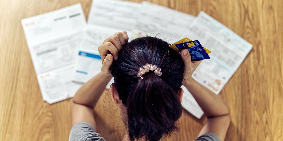 woman looking at credit card debt before buying a home