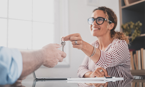 handing keys to first time homebuyer