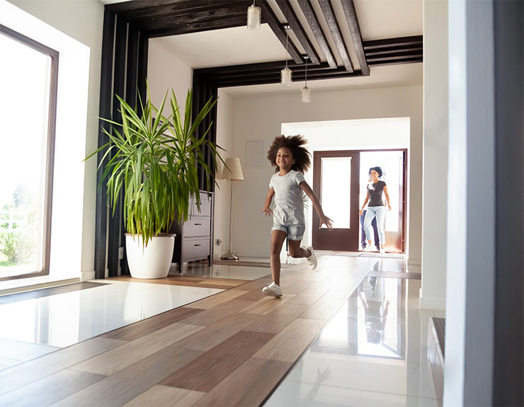 young girl running in big house