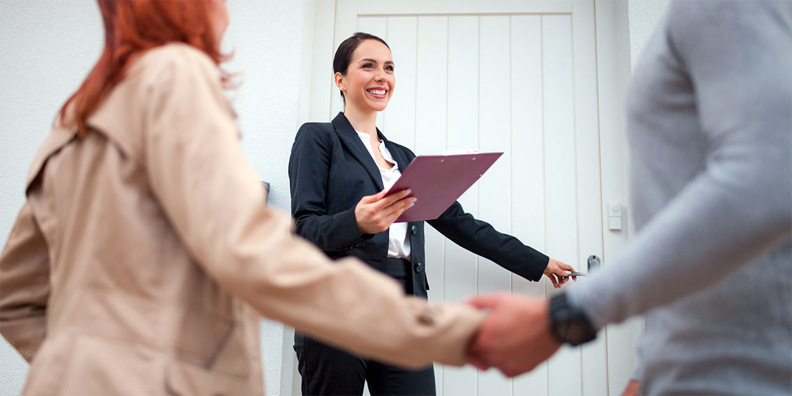 Real estate agent showing couple a home