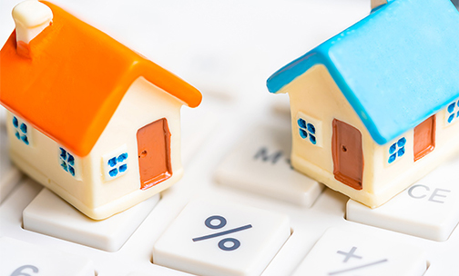 toy houses on top of a calculator
