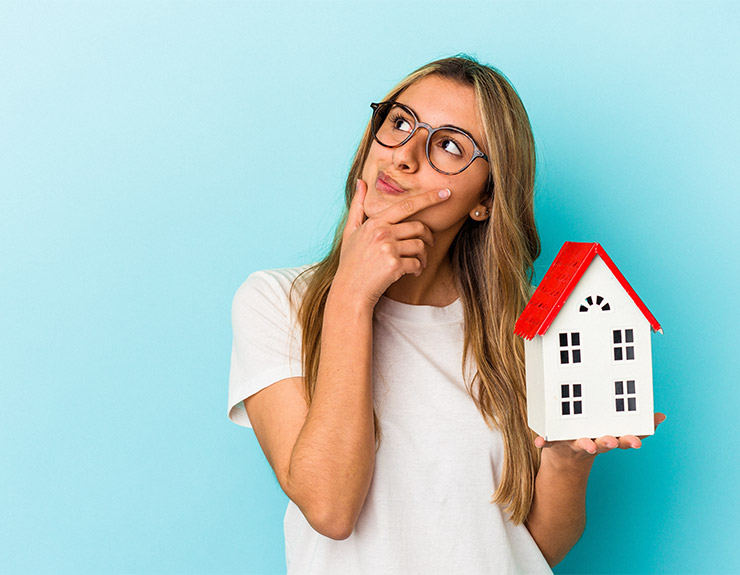 woman hold plastic house
