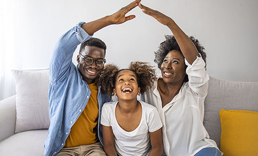 Man, woman and child smiling.