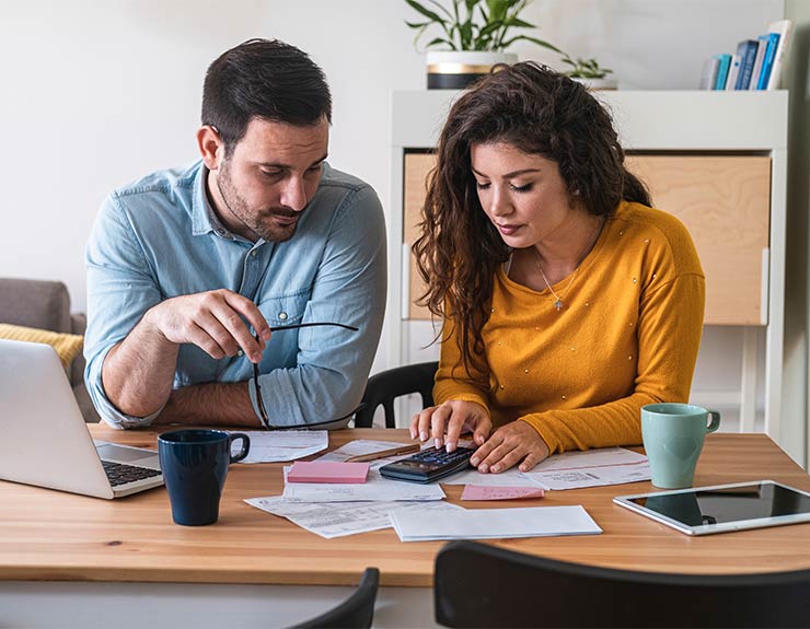 Couple calculating a budget together.