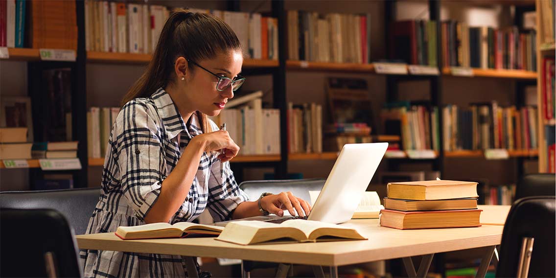 college student researching in library