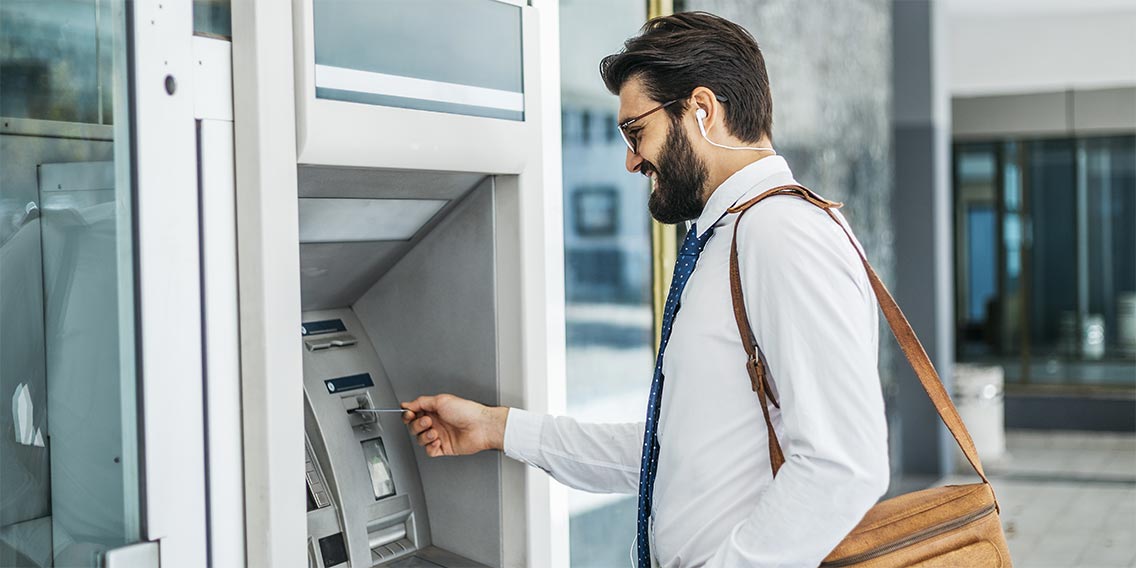 man using credit union credit card