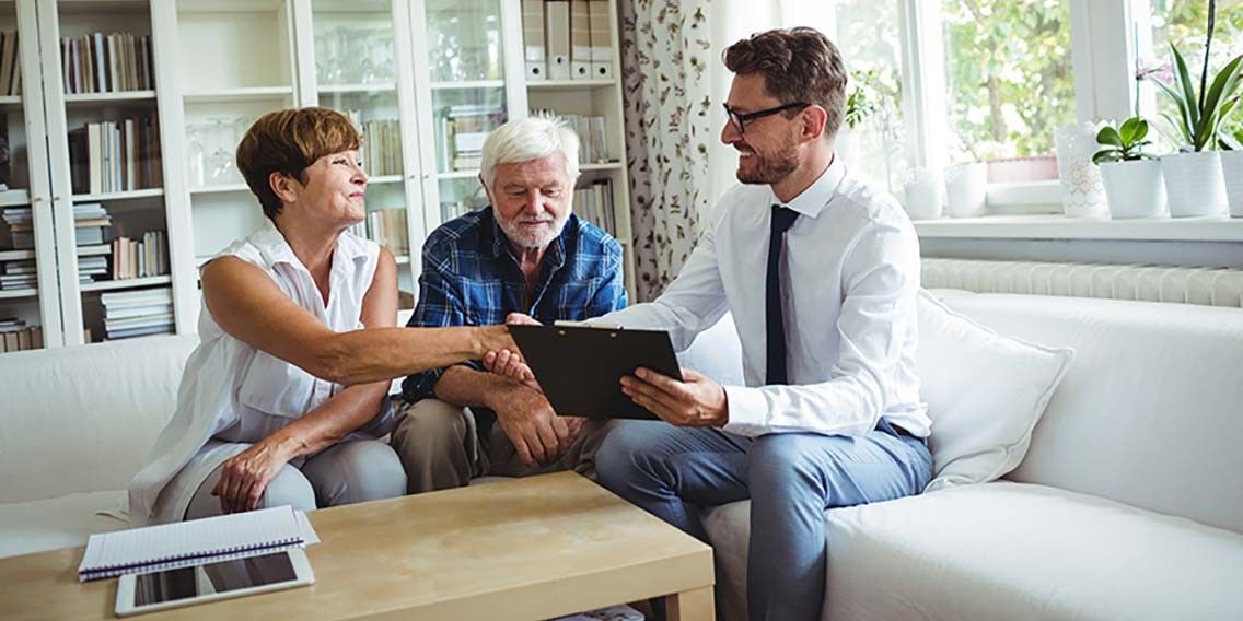 financial advisor shaking hands with one of his clients