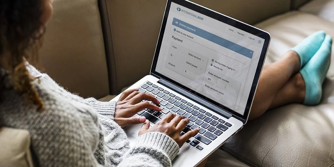 Women on her laptop viewing her PenFed Dashboard