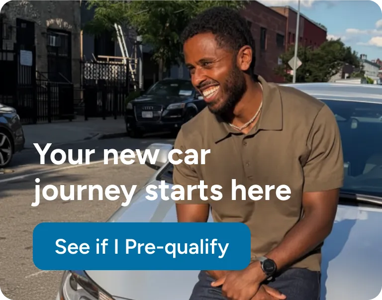 Person standing outside of the car and smiling.