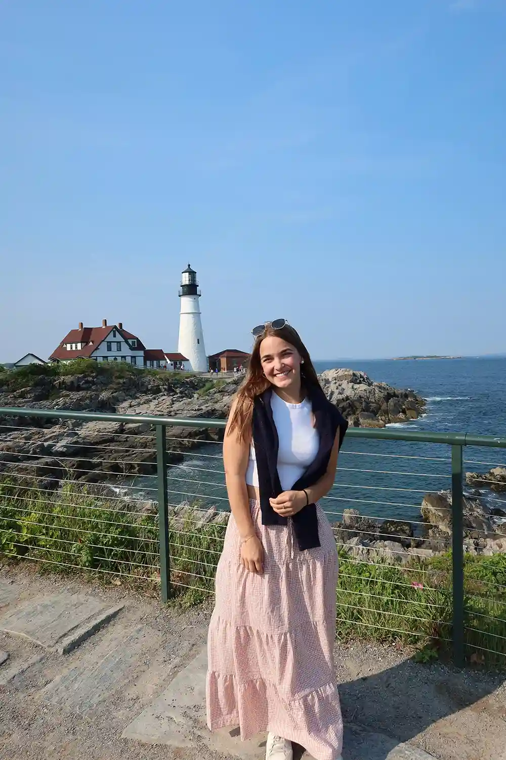 Sam Schlageter standing in front of an ocean