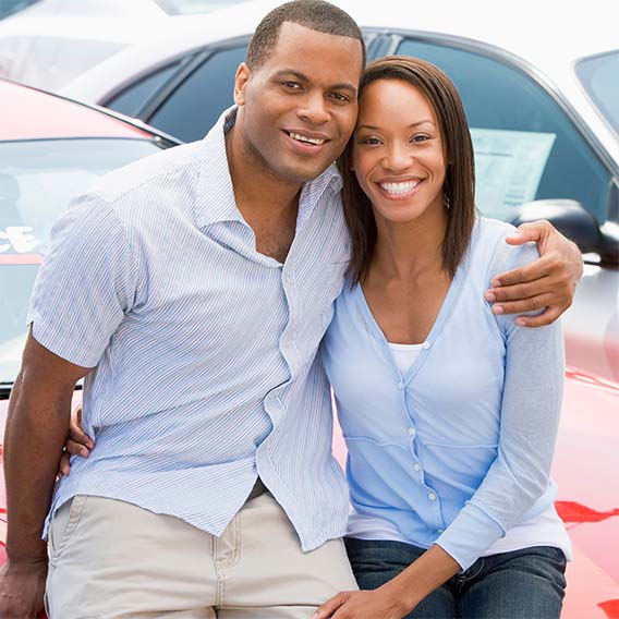 couple looking at new cars