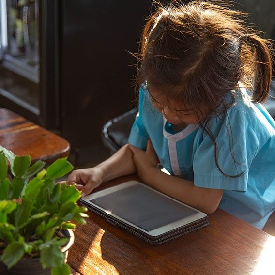 little girl interacting with an ipad