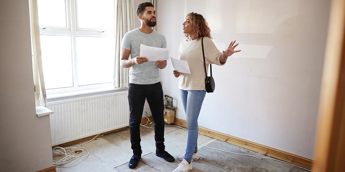 couple looking at a house on a laptop