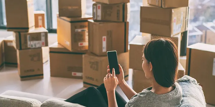 Woman on phone with moving boxes