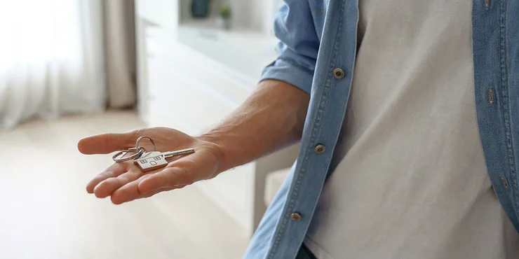 man holding keys to new home