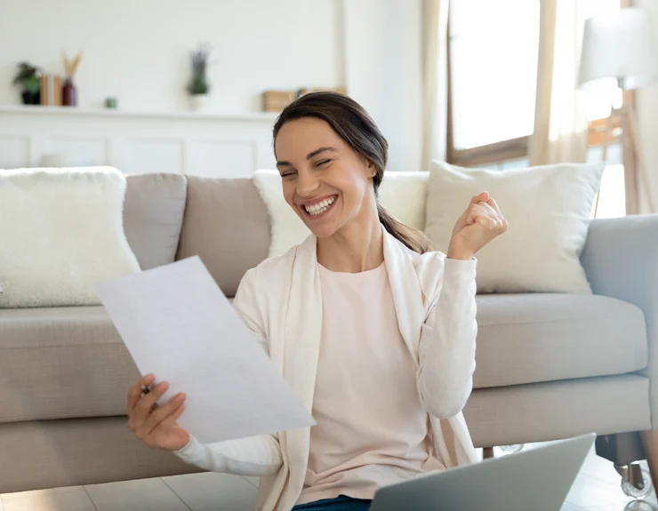 Young women looking at the papers and smiling.