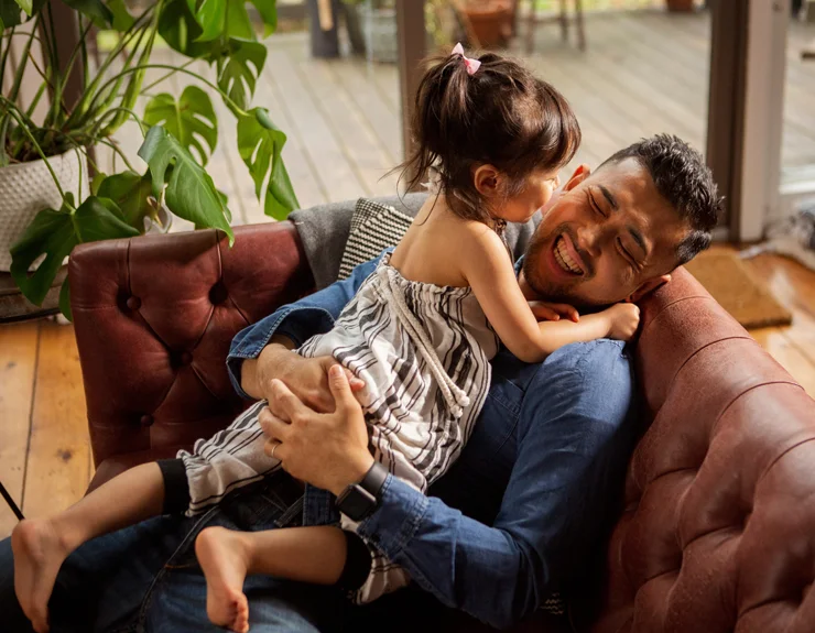 Father and his small daughter having fun at home