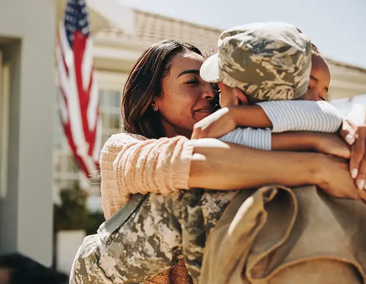 American soldier saying farewell to his family at home
