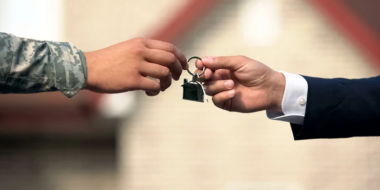 military personnel being handed keys to new home