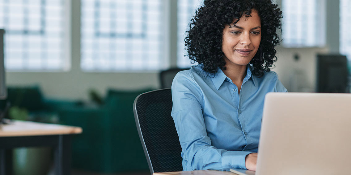 woman at laptop smiling