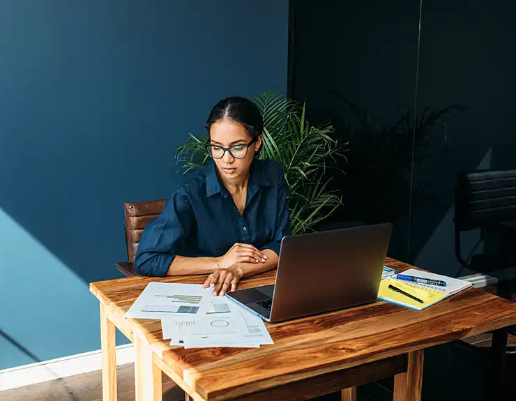 Young woman working with documents from home.