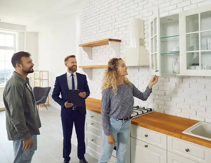 Young couple with real estate agent on a house tour