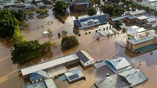 two people standing in front of their first house
