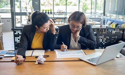 two women discussing home refinancing