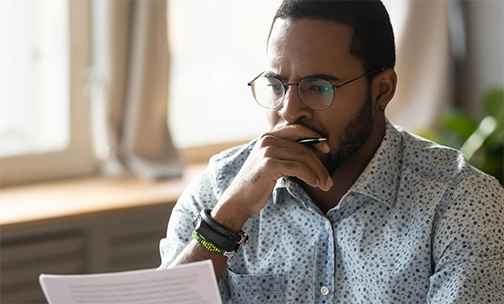 man researching homebuying on laptop