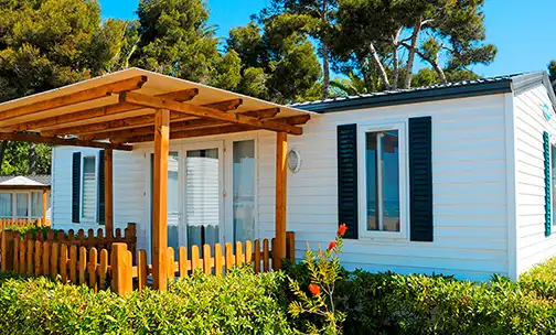 Backyard of the house with a wooden fencing and wooden Pergola