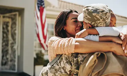 American soldier saying farewell to his family at home