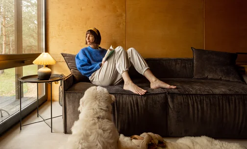 Woman sitting on the sofa and looking outside