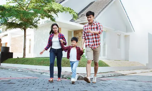 Happy Family walking outside the house