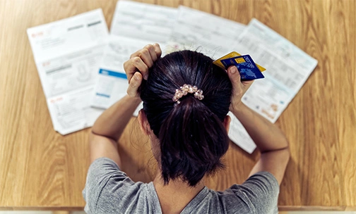 woman looking at credit card debt before buying a home