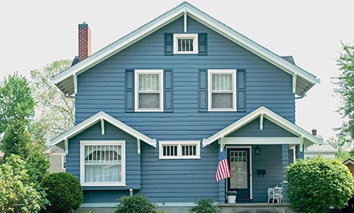 Blue home with American flag on porch
