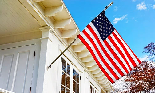 American flag hanging on house.