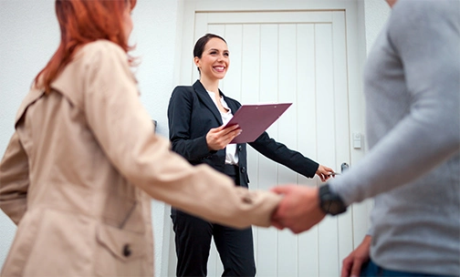 Real estate agent showing couple a home